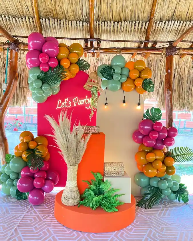 Vibrant Tropical Arch Backdrop with Balloons and Pampas